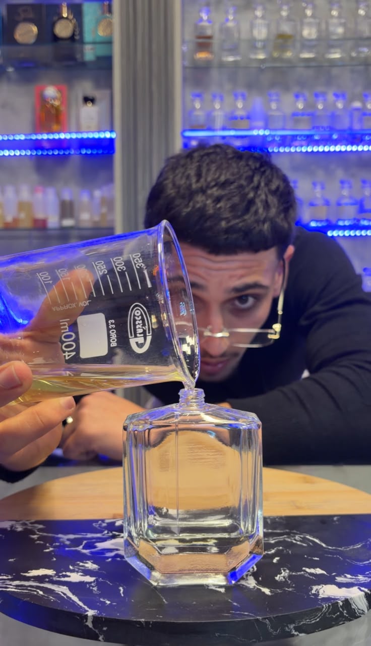 Ghazi Oriental founder pouring perfume oil into a glass bottle